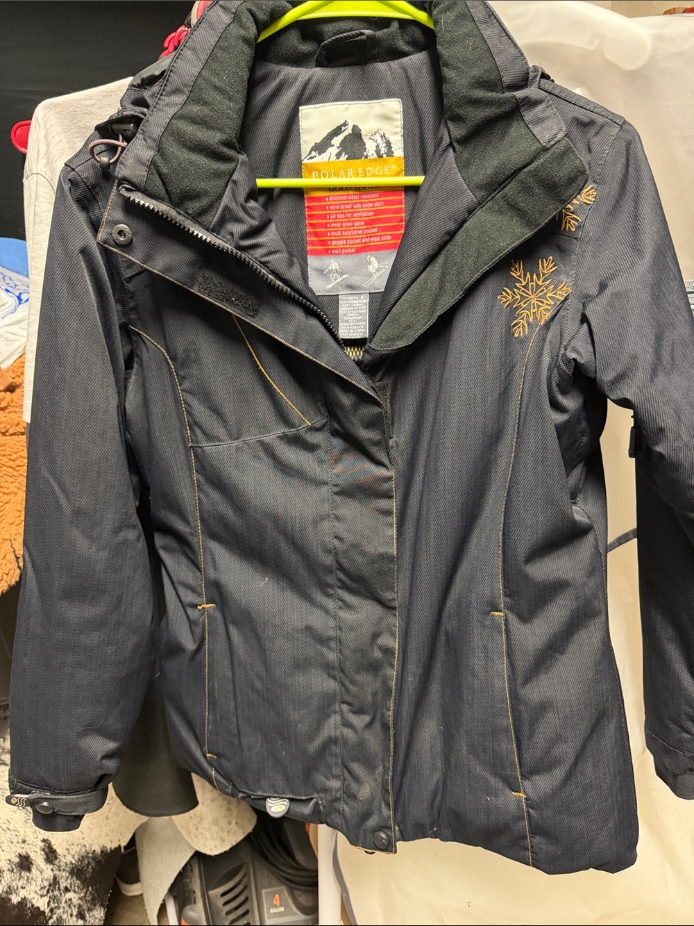 Women's Black Ski Jacket with Gold Snowflake Accent by